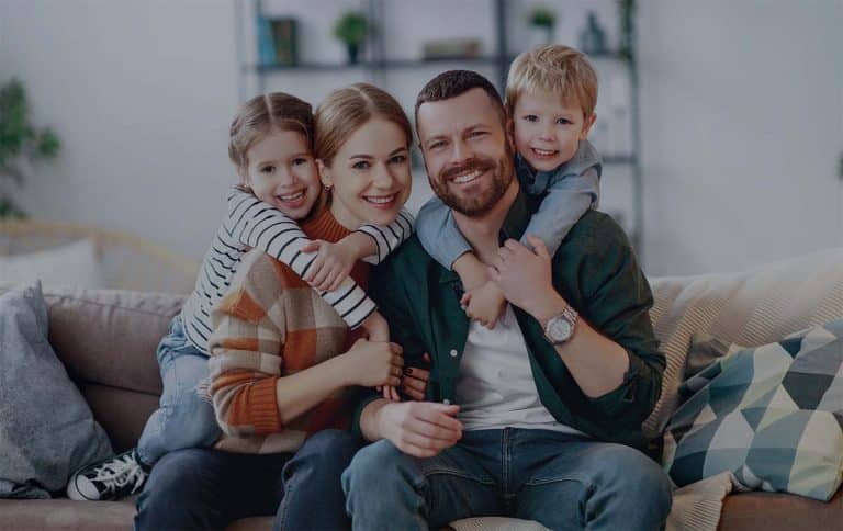 Happy Family Smiling on the Couch